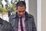 Danilo Valdez Laurente outside court, with his head bowed.