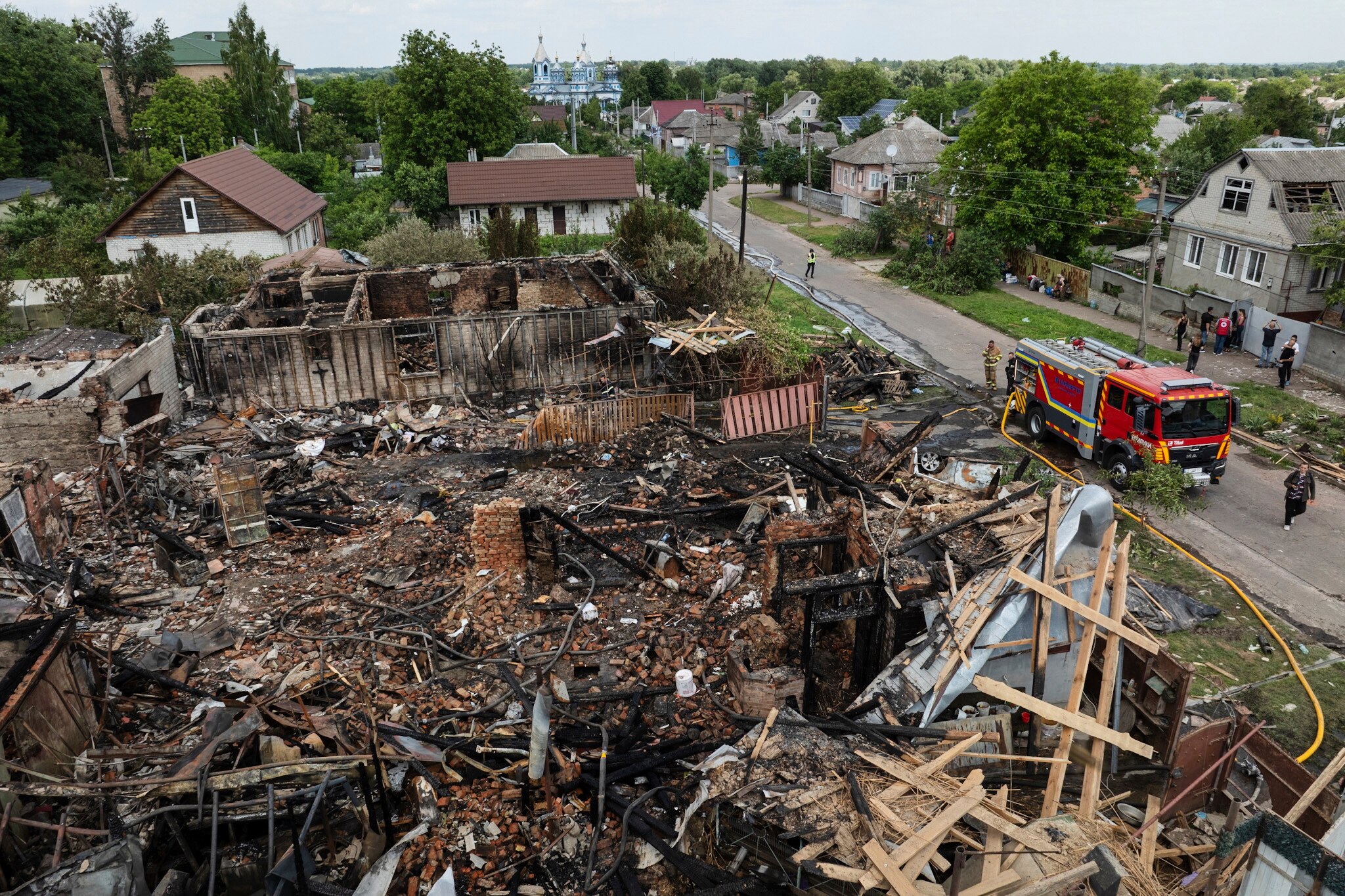 damaged house after firefighters putting off fire 