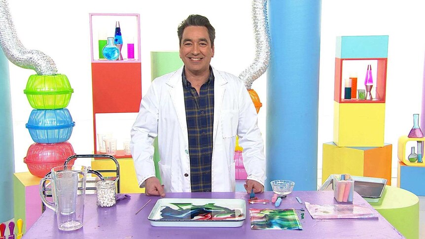 Alex wearing a lab coat, on the Play School Science Time set