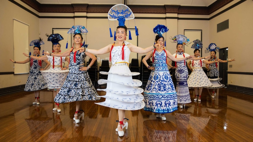 A group of women in traditional costumes dancing.