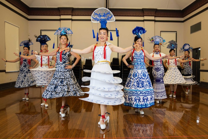 A group of women in traditional costumes dancing.