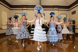 A group of women in traditional costumes dancing.