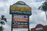 A colourful shopping centre sign that reads "Fresh Fields Shopping Village".