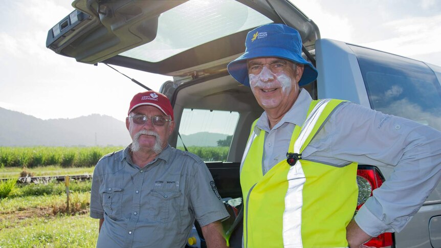 Dr Bill Boyd takes a moment to chat with his support driver Des Burgess alongside the Bruce Highway.