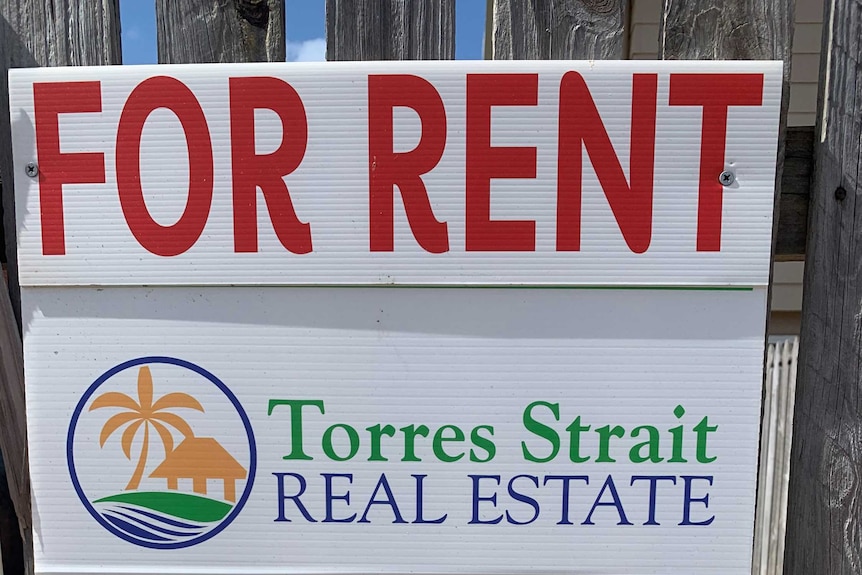 Close up of Torres Strait Real Estate sign nailed to fence.