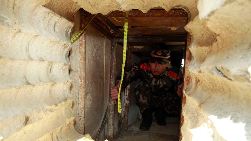 A soldier checks an underground tunnel, leading to Hong Kong from Shenzhen in China's southern Guangdong province.