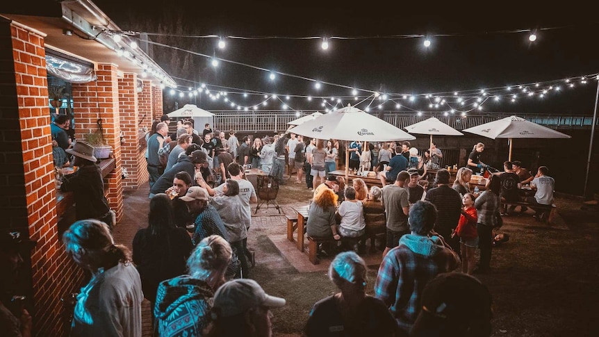 A pub courtyard full of people.