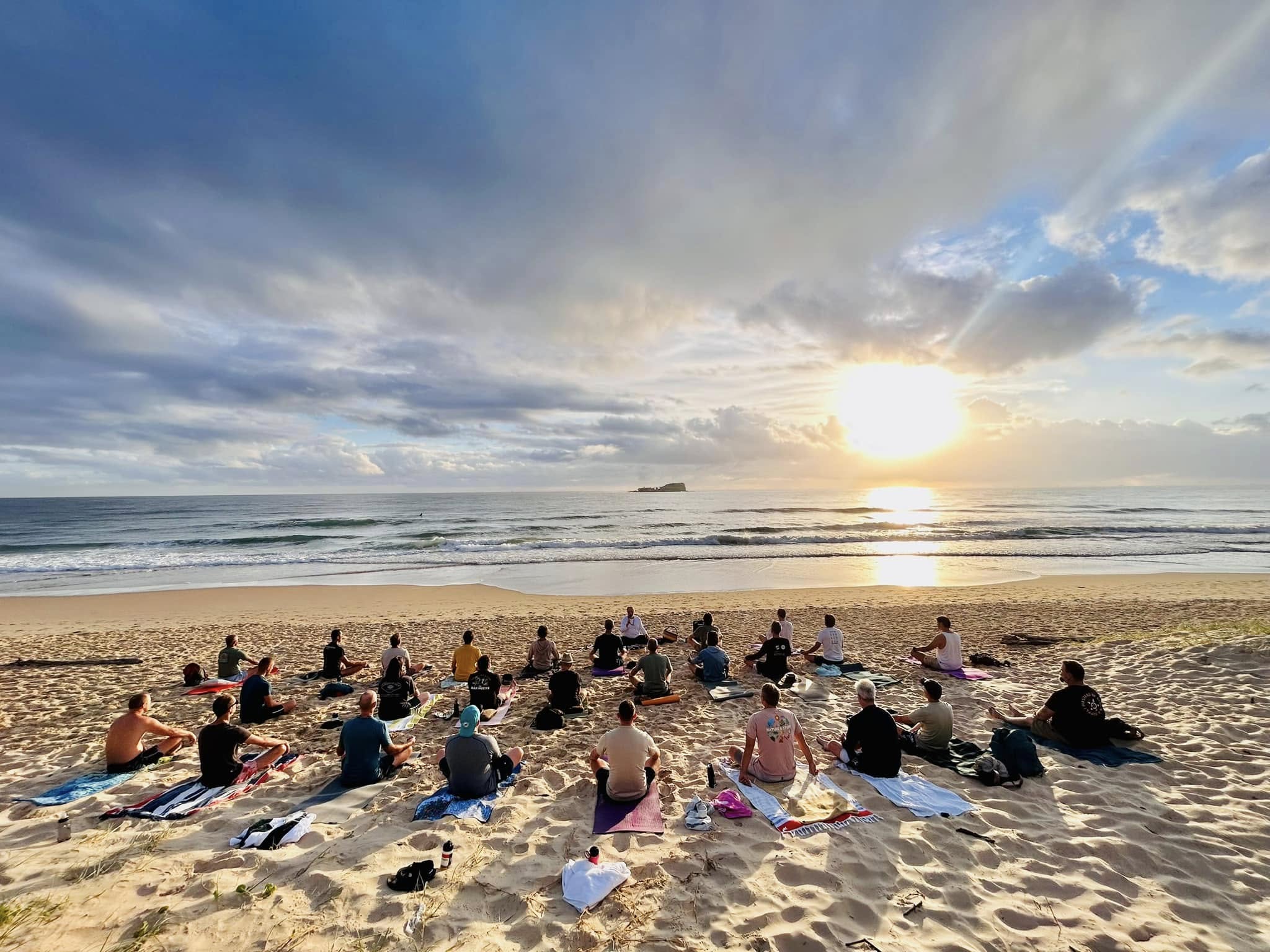Group of men in a circle on Mudjimba beach