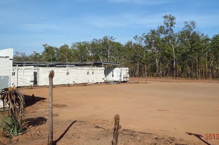 Temporary accommodation units in a bushland clearing.