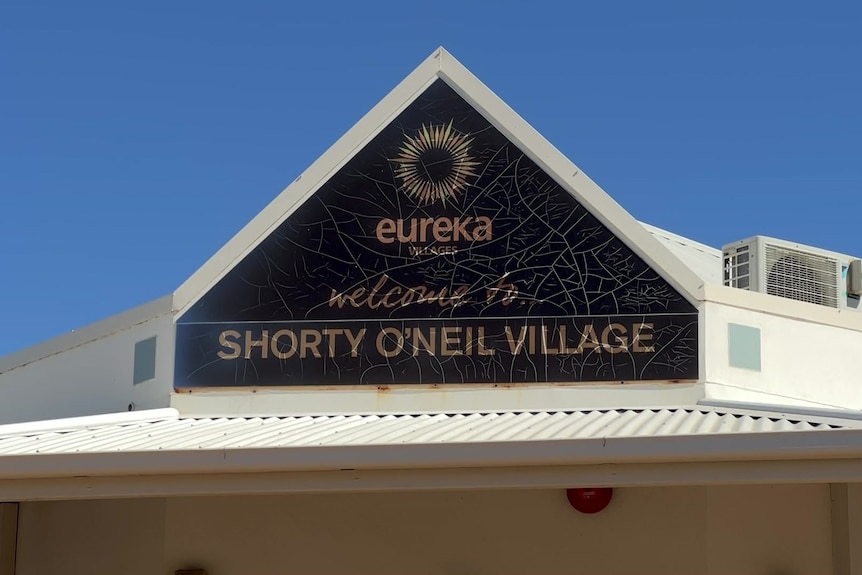 A sign for Shorty O'Neil village, above the building