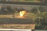 An explosion in a suburban backyard.