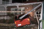 The orange ute veered into a bus stop, crashed through a fence and into the house.