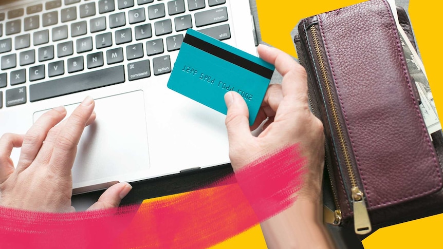 Hands holding a credit card over a laptop for a story about how to control your expensive online shopping habits.