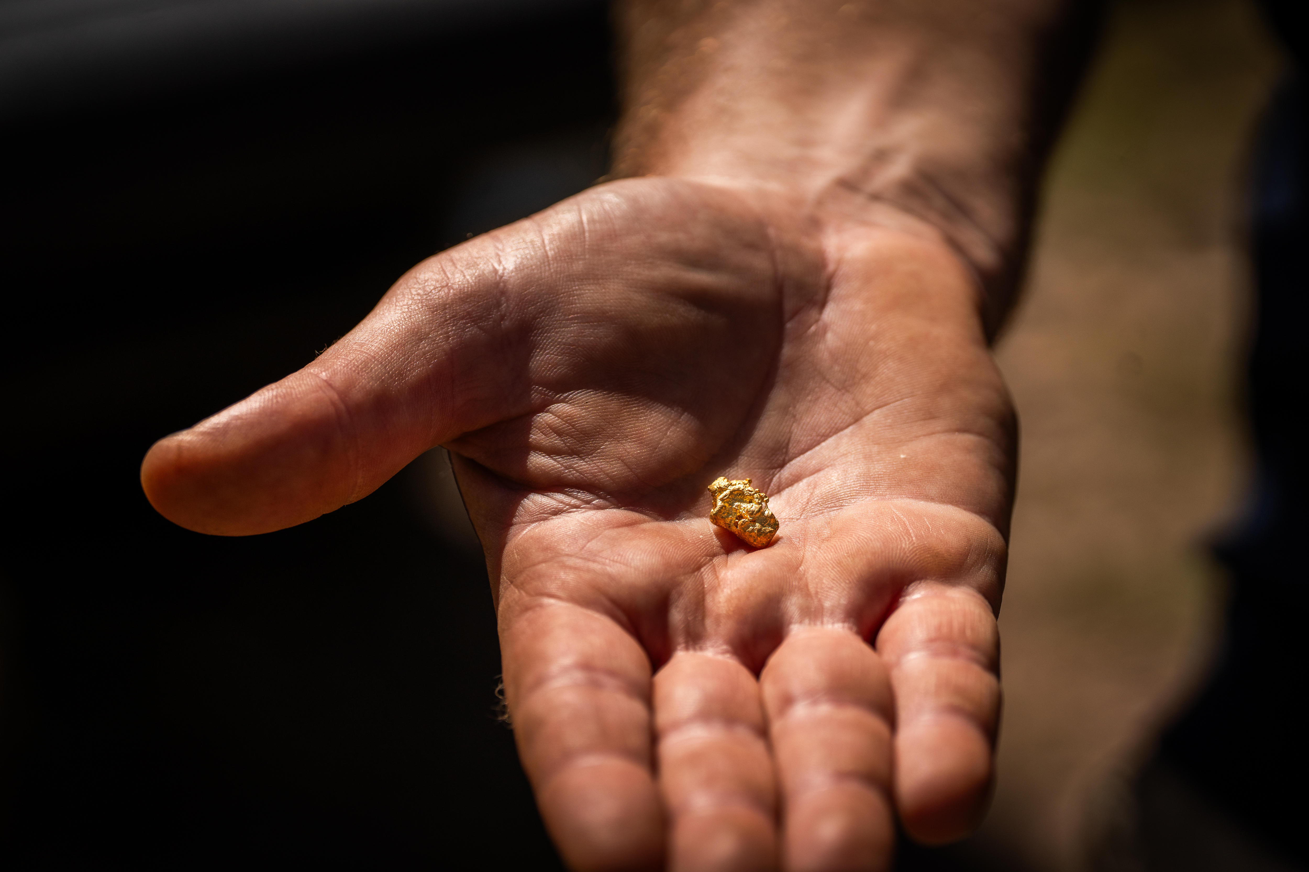 Gold in the middle of an outstretched open hand 