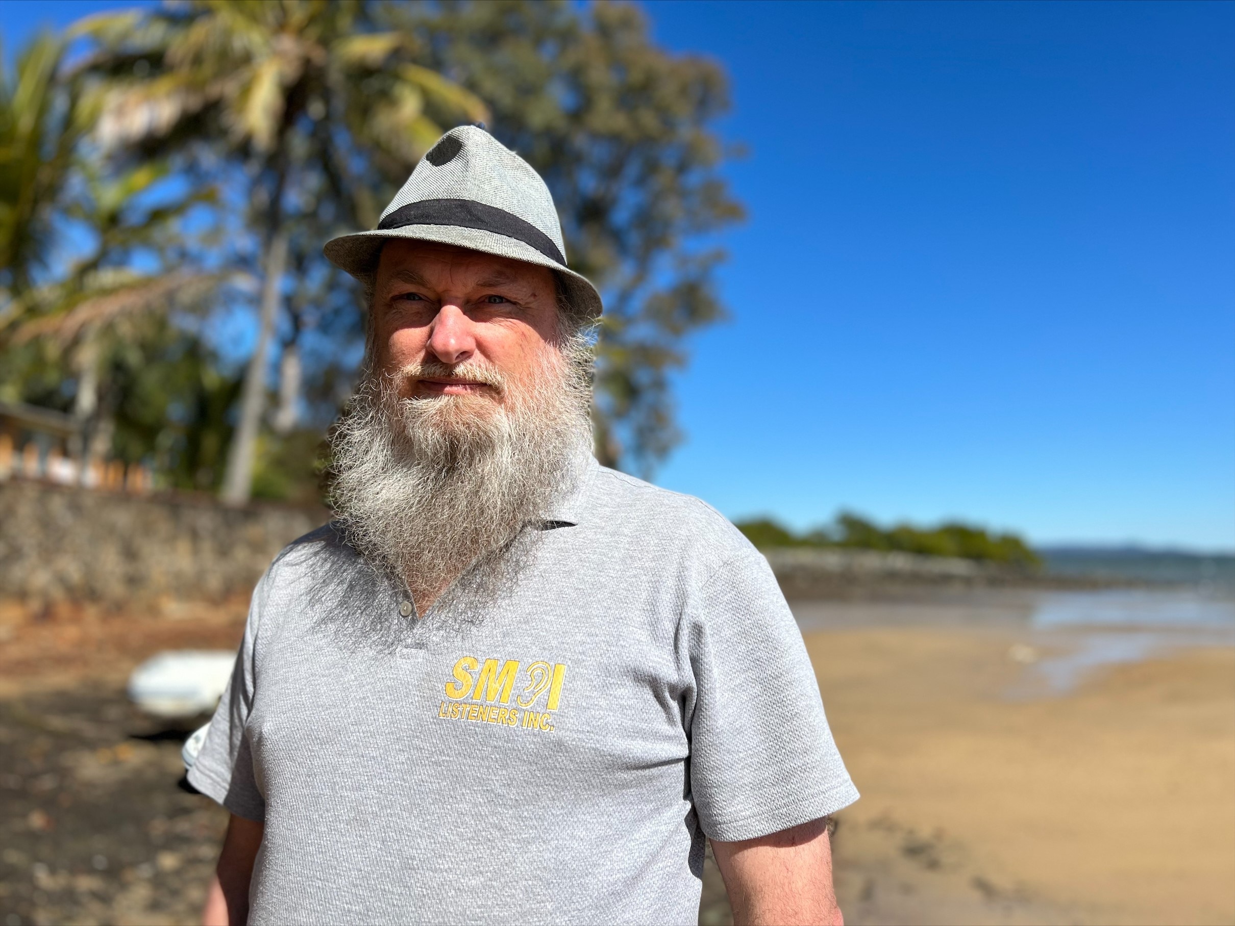 Hilton Travis in a grey hat on the beach. 