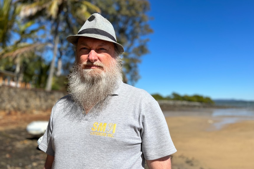 Hilton Travis in a grey hat on the beach. 