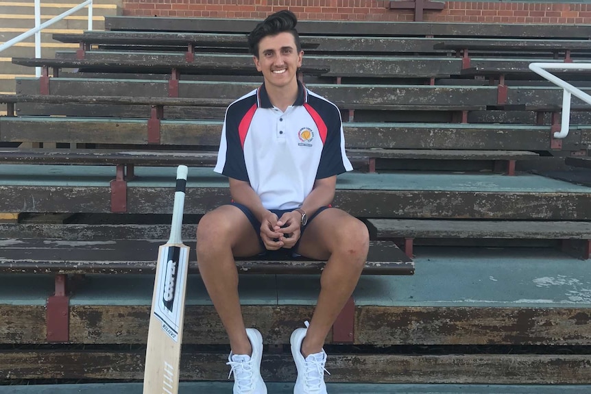 HSC student Marty Jeffrey sits in the cricket stands in Dubbo