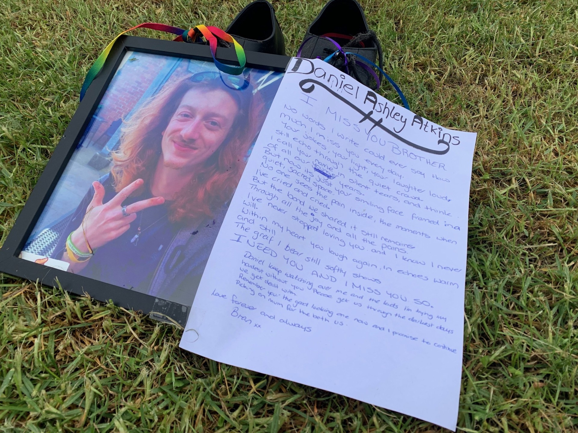 hand written letter next to memorial photo of Daniel Atkins.