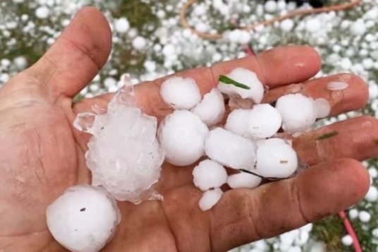 Hailstones in one hand and on the ground at Mount Tyson, west of Toowoomba.
