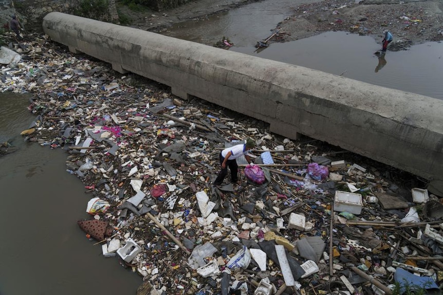 Men participate in a cleanup effort for the Bagmati River in Kathmandu