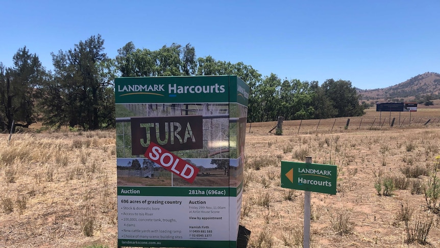 A for sale sign outside a dry farm.