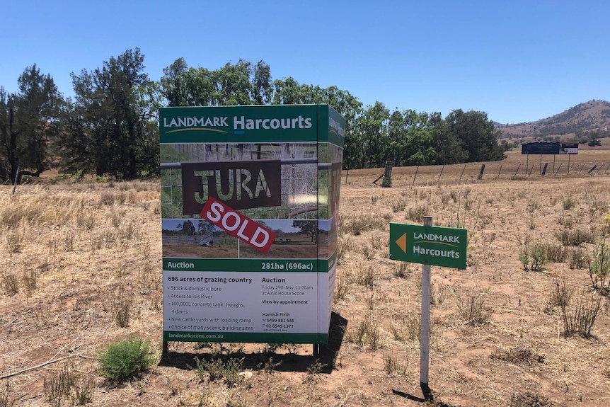 A for sale sign outside a dry farm.