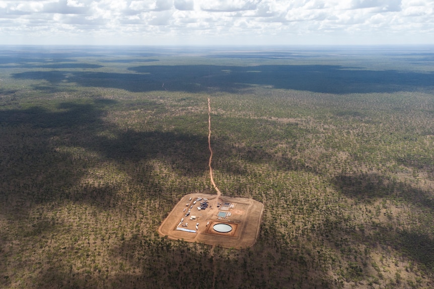An aerial view of an exploration well in the Northern Territory's Beetaloo Basin on a piece of cleared land surrounded by shrubs