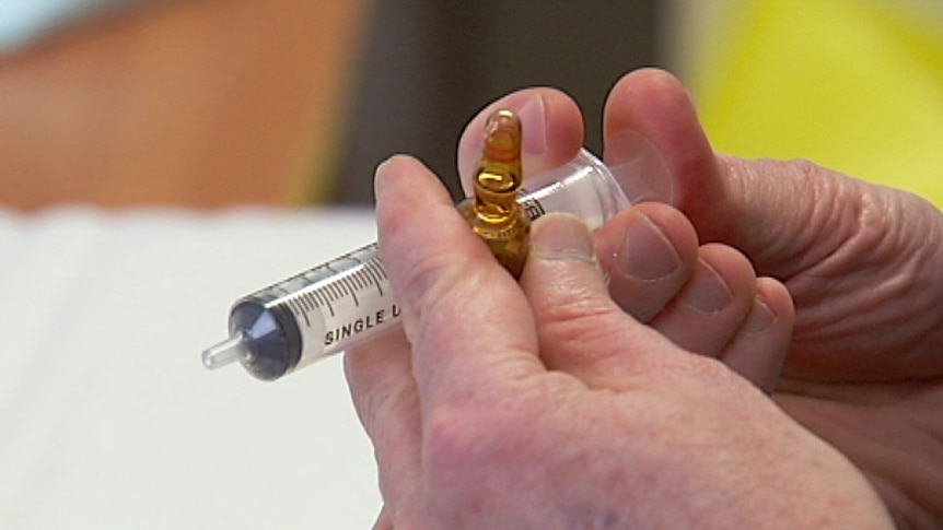 Adelaide university medical professor Gary Wittert prepares to inject testosterone supplement as part of diabetes trial.