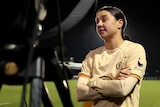 Sam Kerr has her arms folded while speaking to the media on the sidelines after Chelsea's FA Cup game against West Ham.