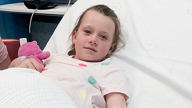 Emma Kiley lies in a hospital bed recovering from a snake bite.