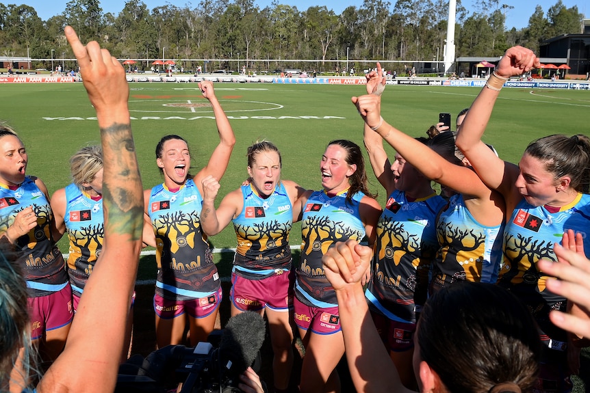 A group of Brisbane Lions AFLW players sing the club song after a win.