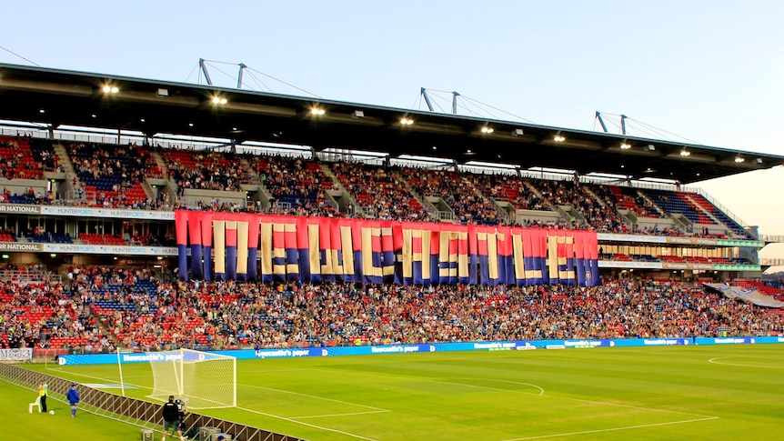 Newcastle Jets fans show their support before an A-League match.