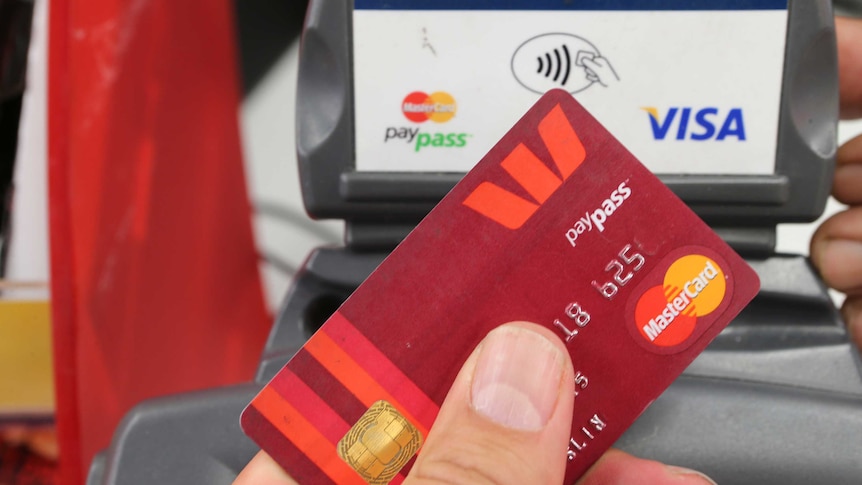 Image of a customer using a tap-and-go credit card in a store.
