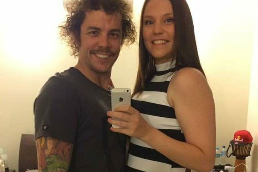 Justin Scott smiles with his wife as they take a selfie.