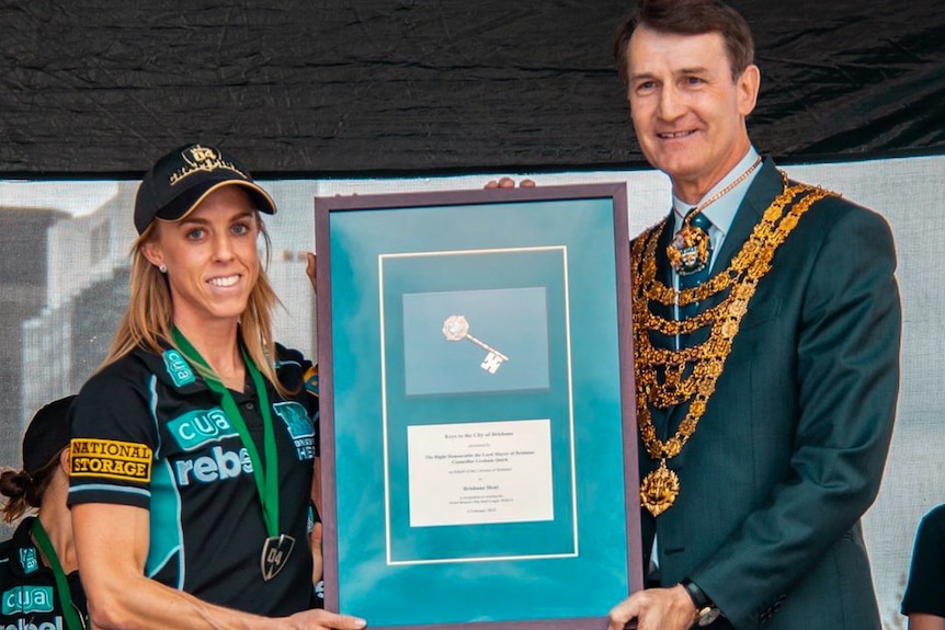 Cricket player receiving the keys to the city.