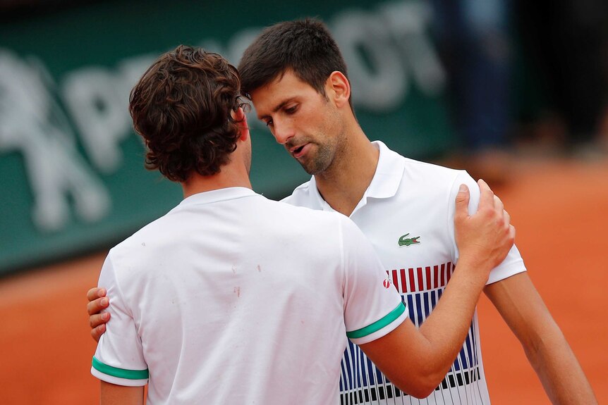 Dominic Thiem shakes hands with Novak Djokovic
