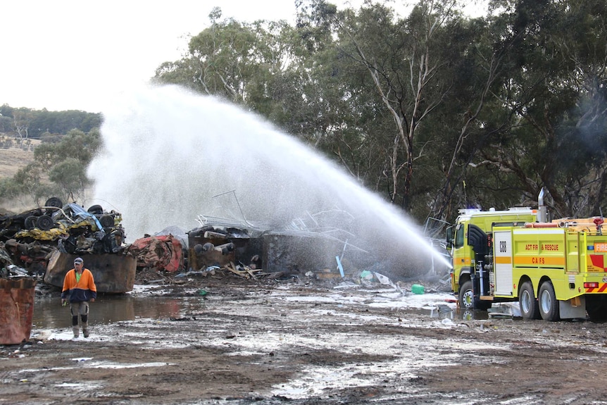 Water from a fire truck is sprayed on a burnt-out structure in Beard.