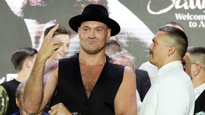 Oleksandr Usyk looks at Tyson Fury