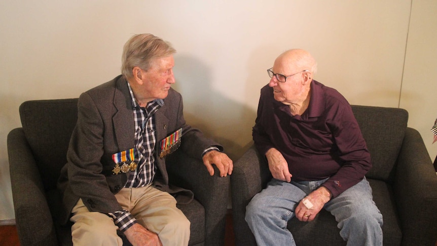 Two Australian war veterans sit and talk