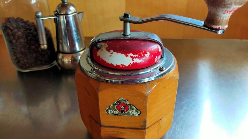 a vintage wooden coffee grinder with a handle on top
