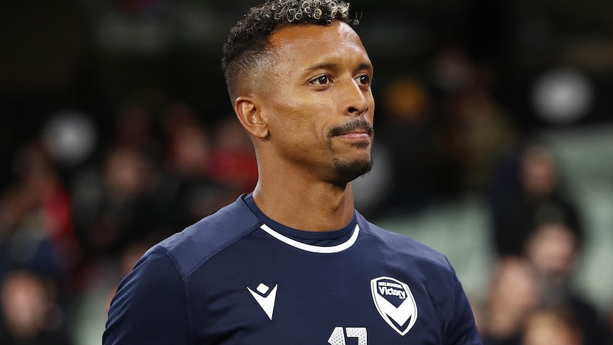 Nani stands and smiles in a Melbourne Victory kit