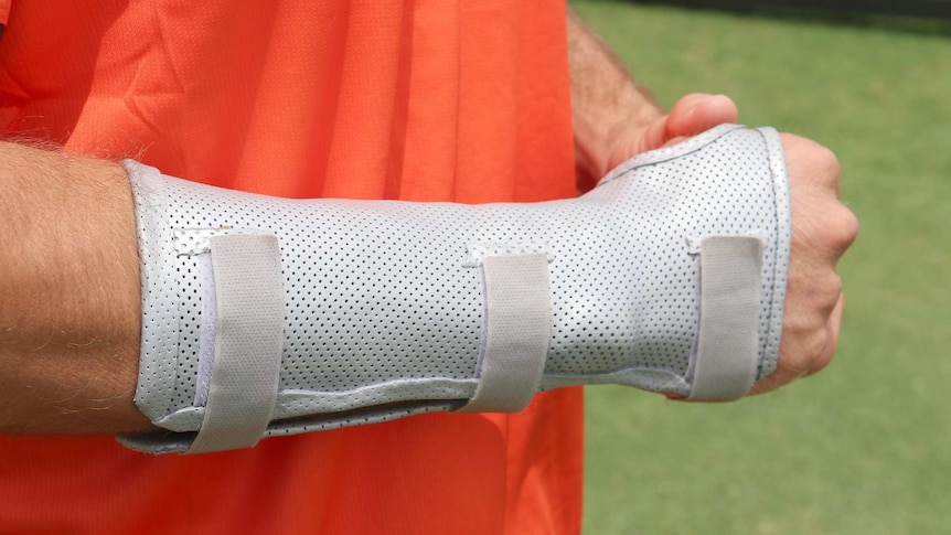 A close-up shot of Mitch Marsh's broken right hand with a protective guard on it.