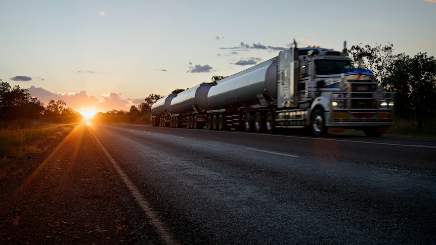 A road train travelling south along the Stuart Highway at sunset, south of Hayes Creek.