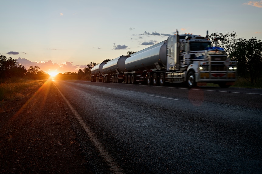 A road train travelling south along the Stuart Highway at sunset, south of Hayes Creek.