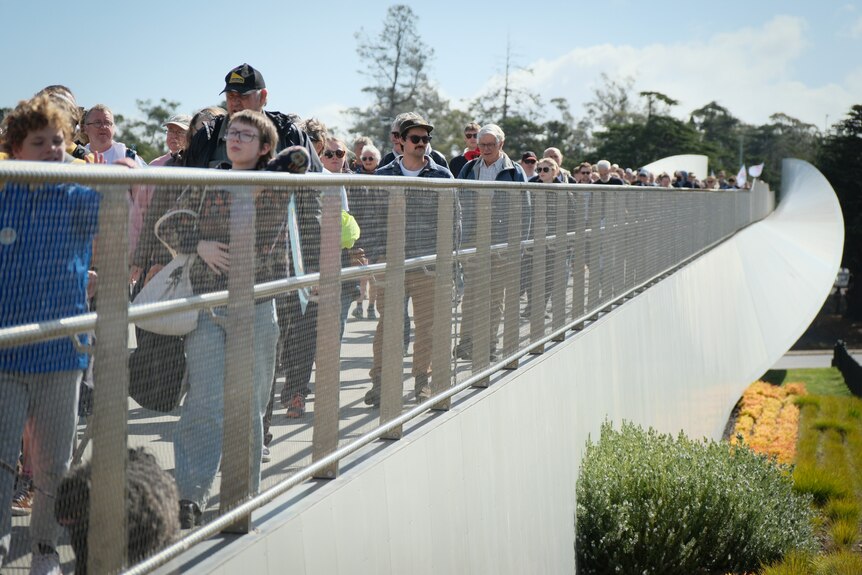 people walking across a Hobart bridge