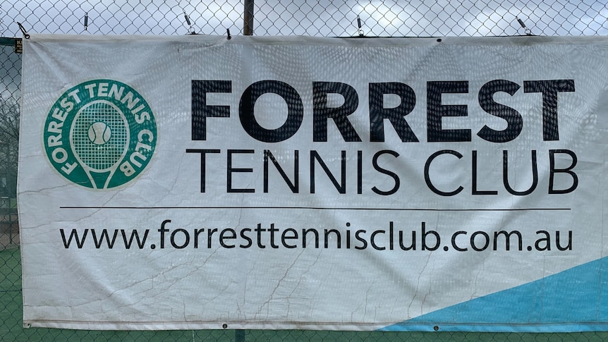 A sign for the Forrest Tennis Club pinned to the fence