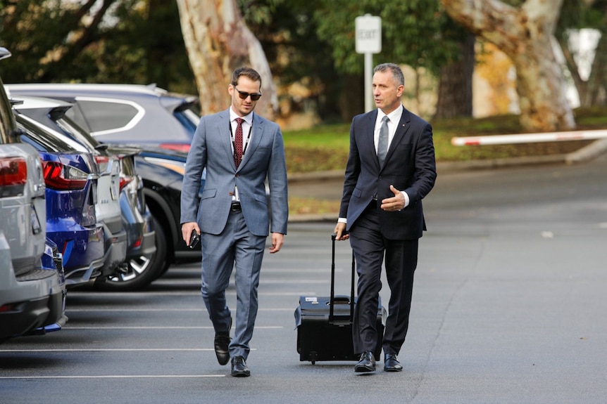 Paul Papalia walking through a car park on the way to parliament.