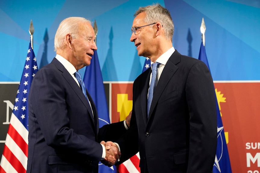 President Joe Biden is greeted by NATO Secretary-General Jens Stoltenberg
