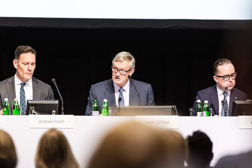 Qantas chairman Leigh Clifford (centre) addresses the company AGM, with Andrew Finch (left) and CEO Alan Joyce (right).