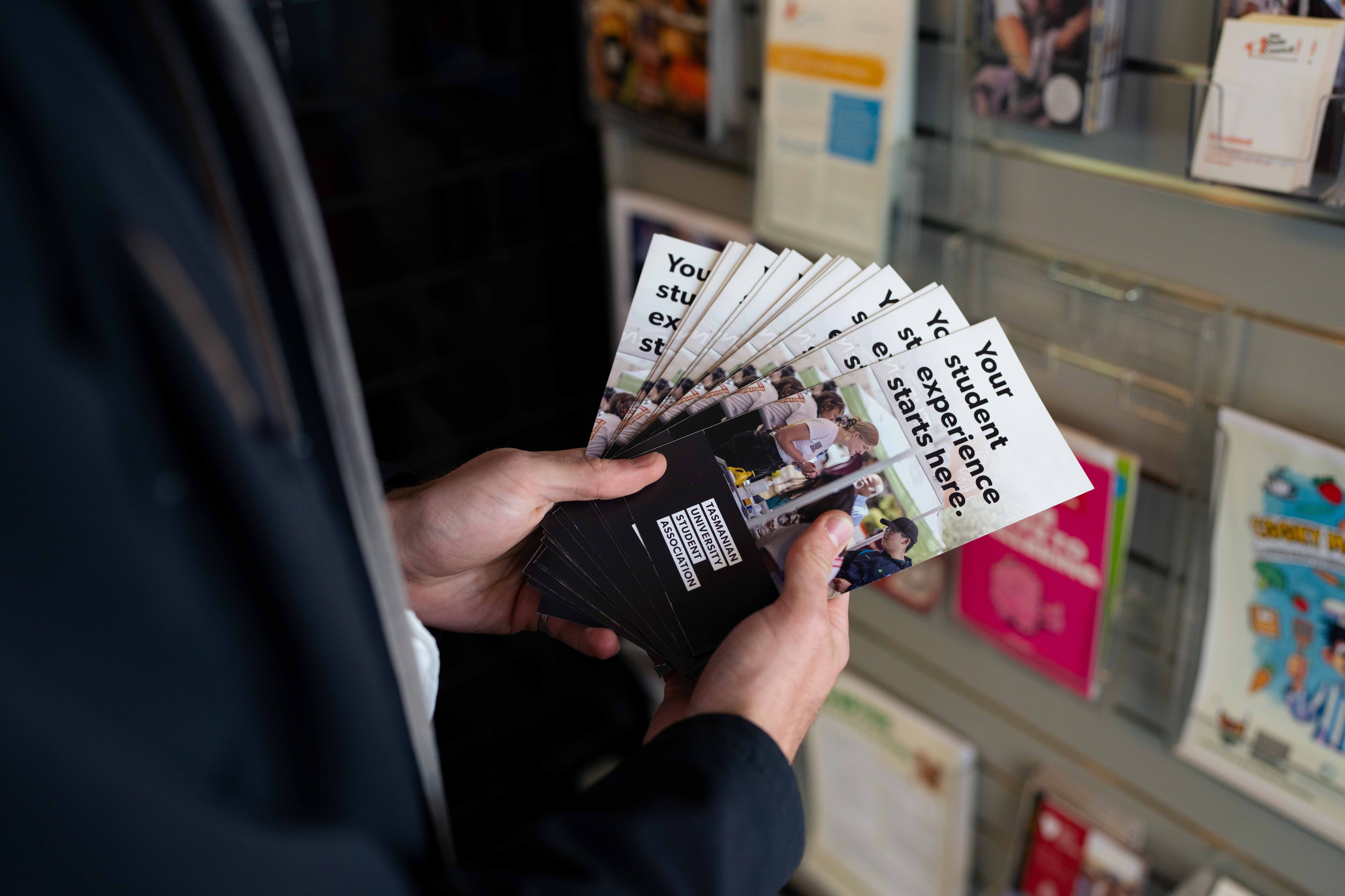 Person holding pamphlets